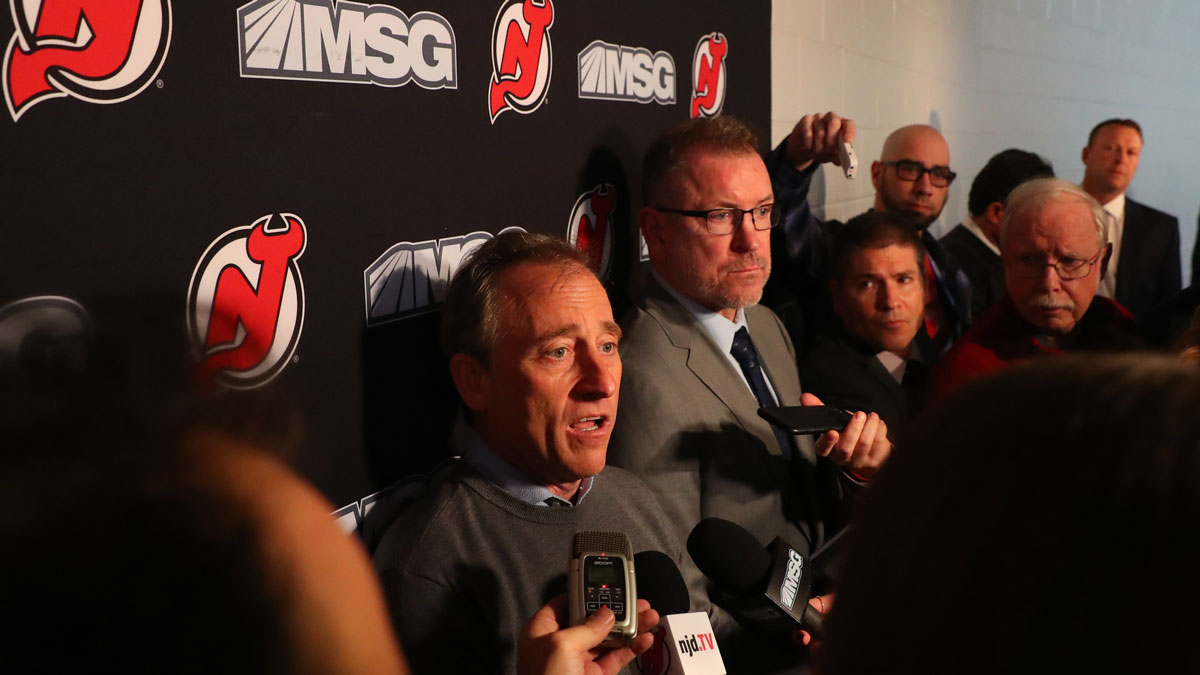 New Jersey Devils owner Joshua Harris speaks to the media alongside interim general manager Tom Fitzgerald after the Devils and former general manager Ray Shero reached an agreement to part ways prior to the start of the NHL game between the New Jersey Devils and the Tampa Bay Lightning at Prudential Center. Martin Brodeur (far right) will act as an advisor alongside Fitzgerald.
