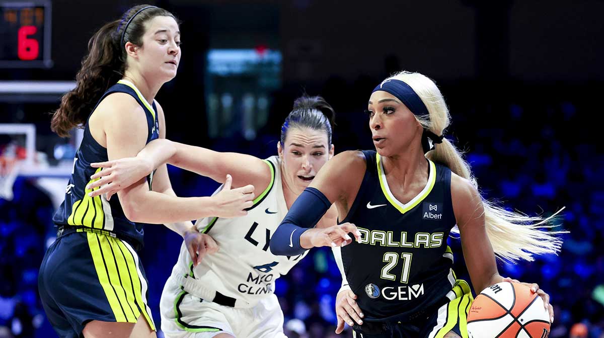 Dallas Wings guard DiJonai Carrington (21) drives to the basket past Minnesota Lynx forward Bridget Carleton (6) during the second half at College Park Center.
