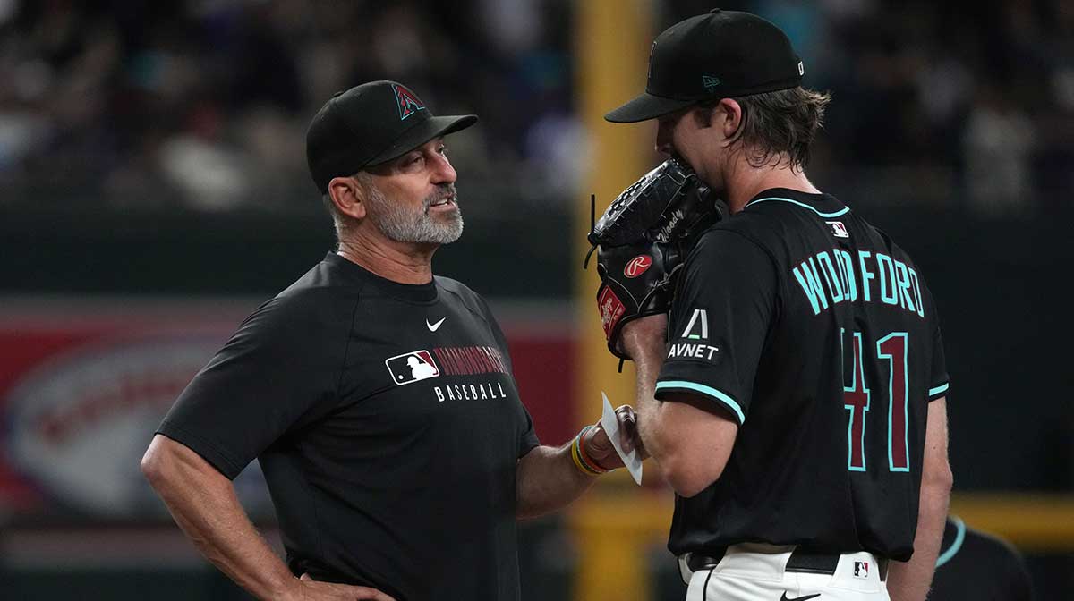Arizona Diamondbacks manager Torey Lovullo (17) talks to pitcher Jake Woodford (41) in the ninth inning during a game against the St. Louis Cardinals at Chase Field.