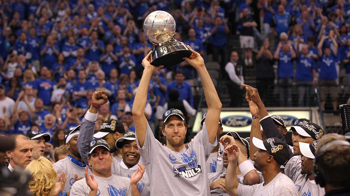 Dallas Mavericks forward Dirk Nowitzki (41) hoist the Western Conference champions trophy after game five against the Oklahoma City Thunder for the Western Conference Finals of the 2011 NBA playoffs at American Airlines Center. The Mavs beat the Thunder 100-96.