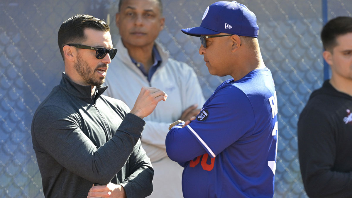 Los Angeles Dodgers Executive Vice President and General Manager Brandon Gomes talks with manager Dave Roberts (30) during spring training at Camelback Ranch.