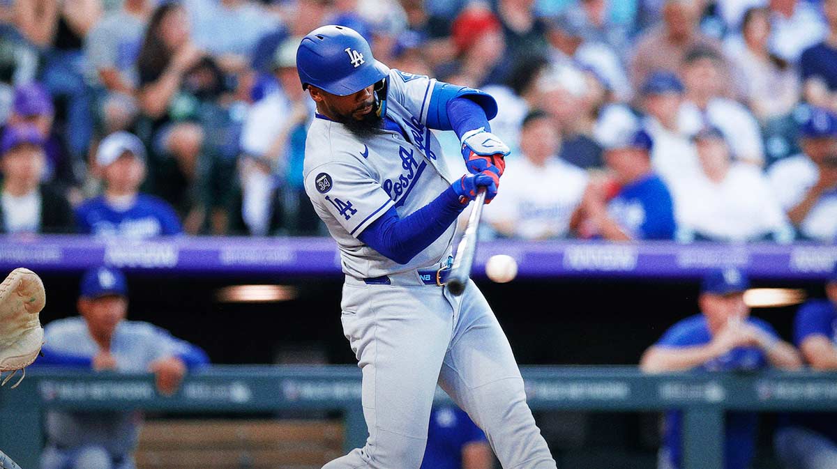 Los Angeles Dodgers right fielder Teoscar Hernandez (37) hits a single in the third inning against the Colorado Rockies at Coors Field.
