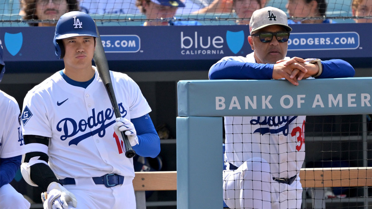 Dodgers designated hitter Shohei Ohtani (17) and manager Dave Roberts (30) look on from the dugout in the seventh inning against the Los Angeles Angels at Dodger Stadium