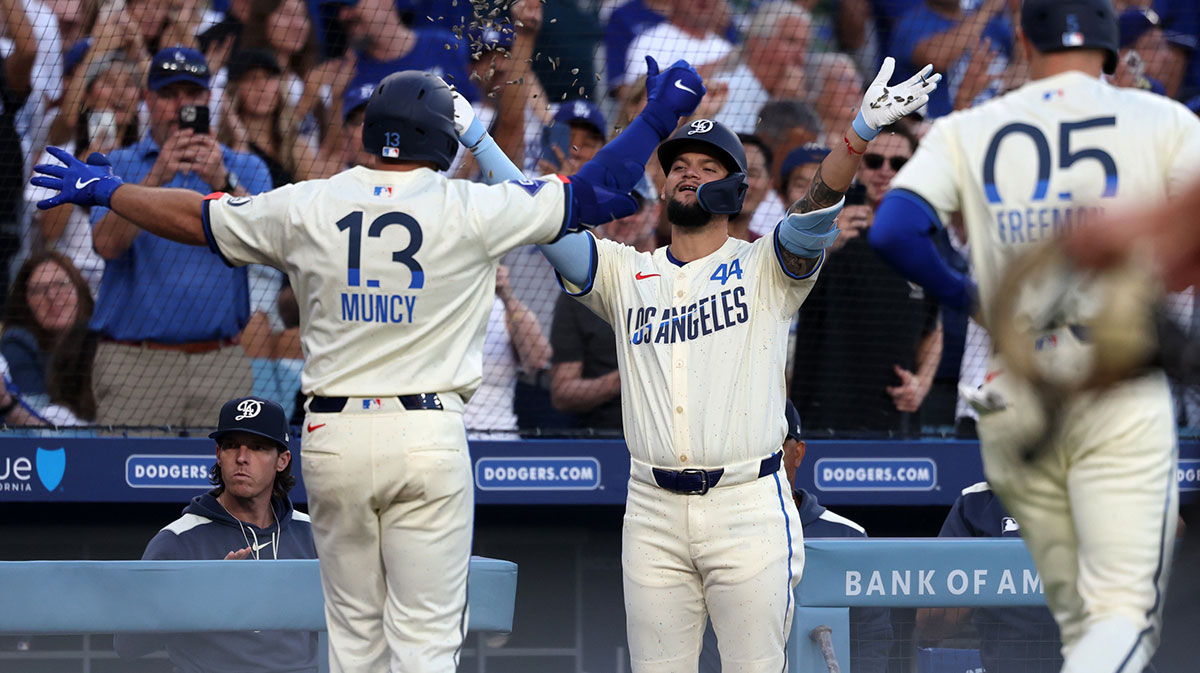 Los Angeles Dodgers third baseman Max Muncy (13) is greeted by center fielder Andy Pages (44) after hitting a two-run home run during the fourth inning against the Toronto Blue Jays at Dodger Stadium.