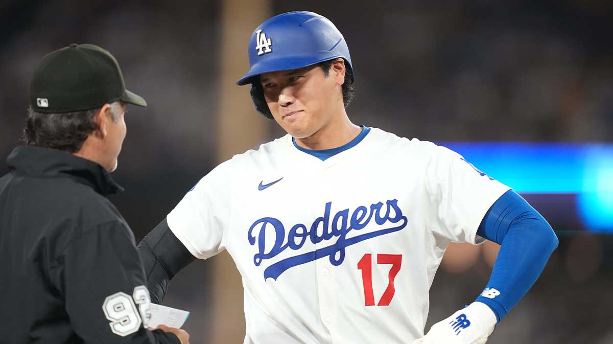 Dodgers designated hitter Shohei Ohtani (17) talks with third base umpire James Hoye (92) in the seventh inning against the Toronto Blue Jays at Dodger Stadium