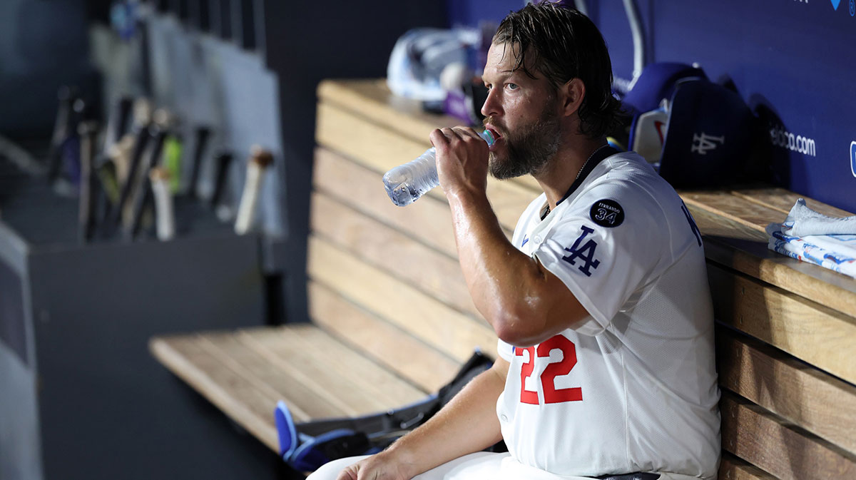 Los Angeles Dodgers starting pitcher Clayton Kershaw (22) drinks water in the dugout during the fourth inning against the Cincinnati Reds at Dodger Stadium.