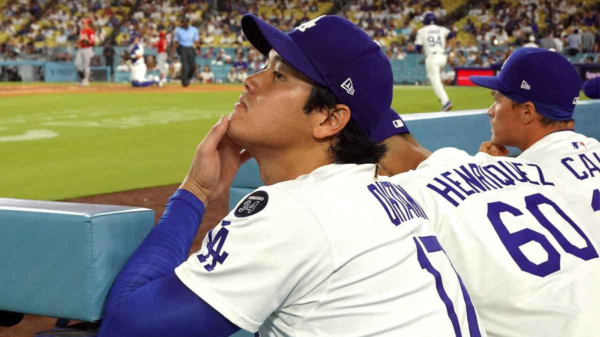 Los Angeles Dodgers starting pitcher Shohei Ohtani (17) watches from the dugout in the ninth inning against the Cincinnati Reds at Dodger Stadium.