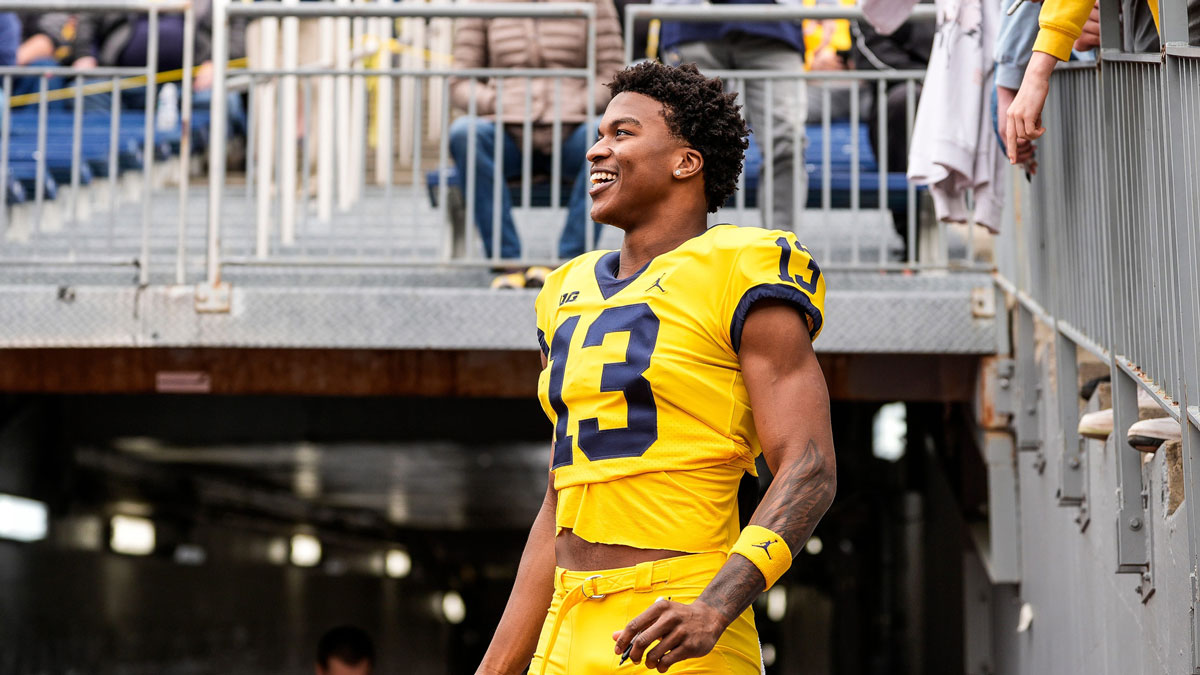 Michigan wide receiver Donaven McCulley (13) watches a play as he signs autographs for fans during the second half of the spring game at Michigan Stadium