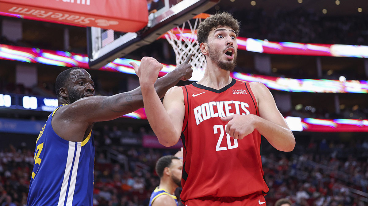 Houston Rockets center Alperen Sengun (28) and Golden State Warriors forward Draymond Green (23) react after a play during the third quarter at Toyota Center.