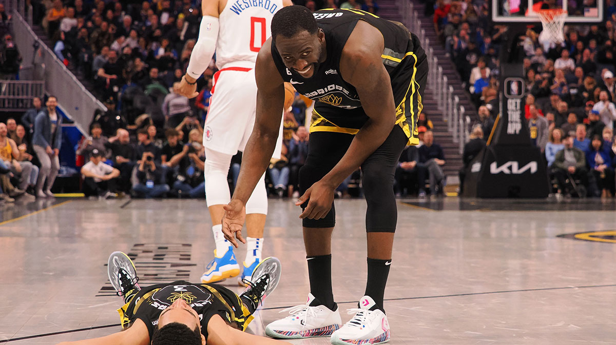 Golden State Warriors center Draymond Green (23) smiles as he helps up guard Jordan Poole (3) after Poole drew an offensive charge from Los Angeles Clippers point guard Russell Westbrook (0) during the third quarter