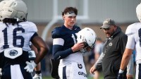 Penn State quarterback Drew Allar puts his helmet on during a practice session outside Holuba Hall