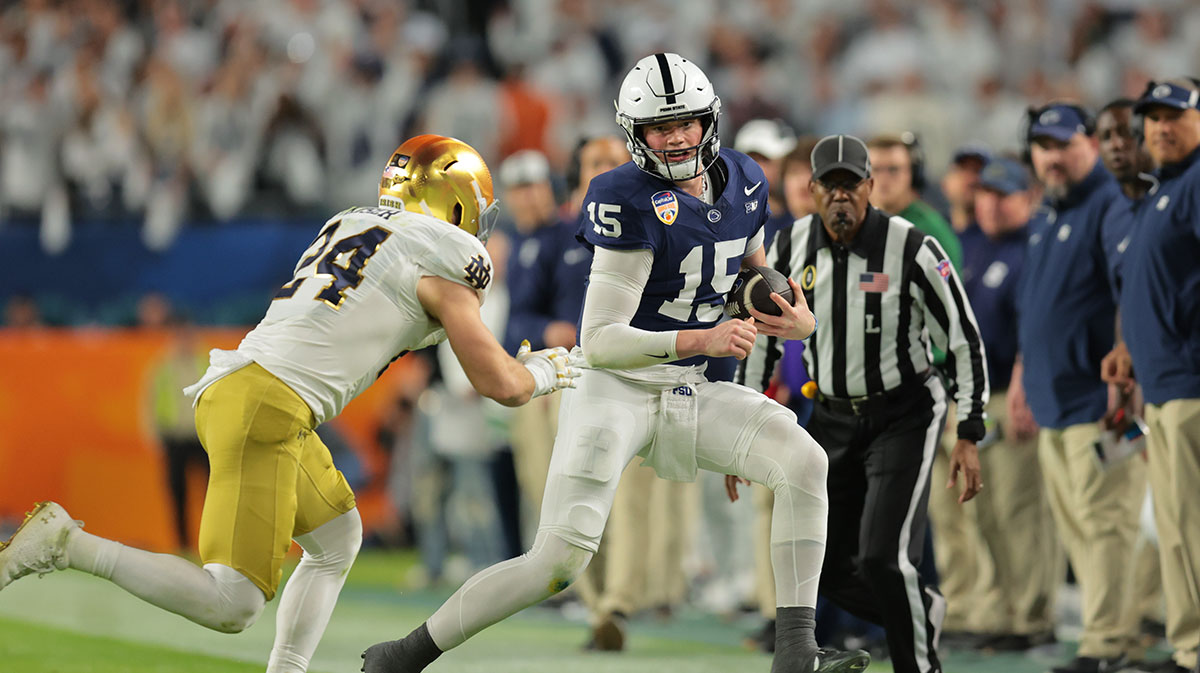Penn State Nittany Lions quarterback Drew Allar (15) runs the ball pressured by Notre Dame Fighting Irish linebacker Jack Kiser (24) in the first half in the Orange Bowl at Hard Rock Stadium.