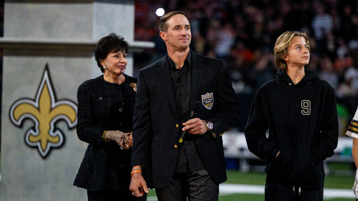 New Orleans Saints owner Gayle Benson puts a jacket on former New Orleans Saints quarterback Drew Brees as he is inducted into the New Orleans Saints Hall of Fame during a halftime ceremony
