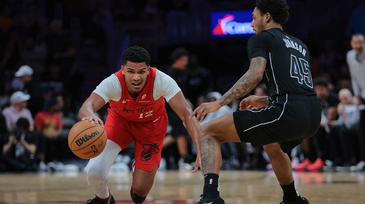 Miami Heat guard Dru Smith (12) slips while dribbling the basketball against Brooklyn Nets guard Keon Johnson (45) during the second quarter