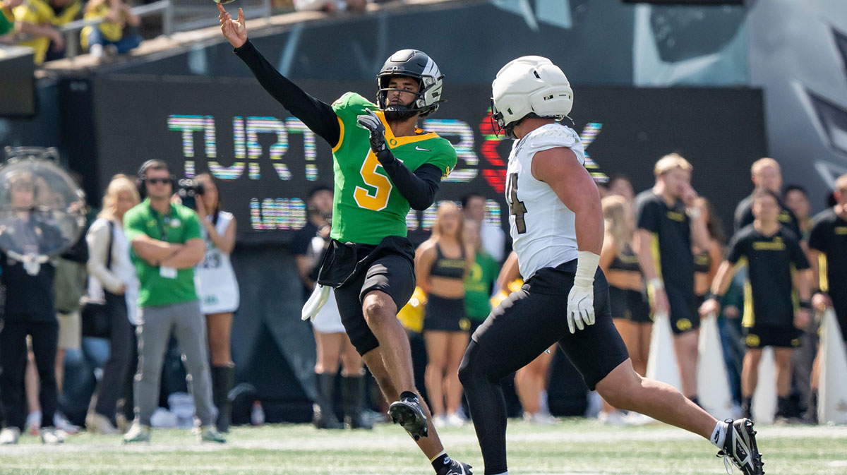 Combat Ducks quarterback Dante Moore throws out a pass as the Fighting Ducks face off against Mighty Oregon in the Oregon Ducks spring game on April 26, 2025, at Autzen Stadium in Eugene.