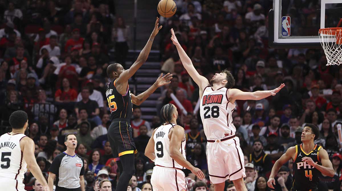Phoenix Suns forward Kevin Durant (35) shoots the ball as Houston Rockets center Alperen Sengun (28) defends during the third quarter at Toyota Center.