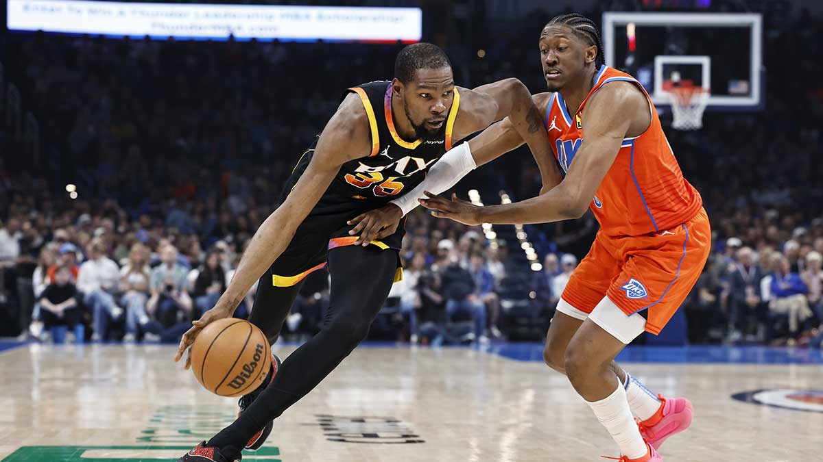 Phoenix Suns forward Kevin Durant (35) moves the ball as Oklahoma City Thunder forward Jalen Williams (8) defends during the first half at Paycom Center.