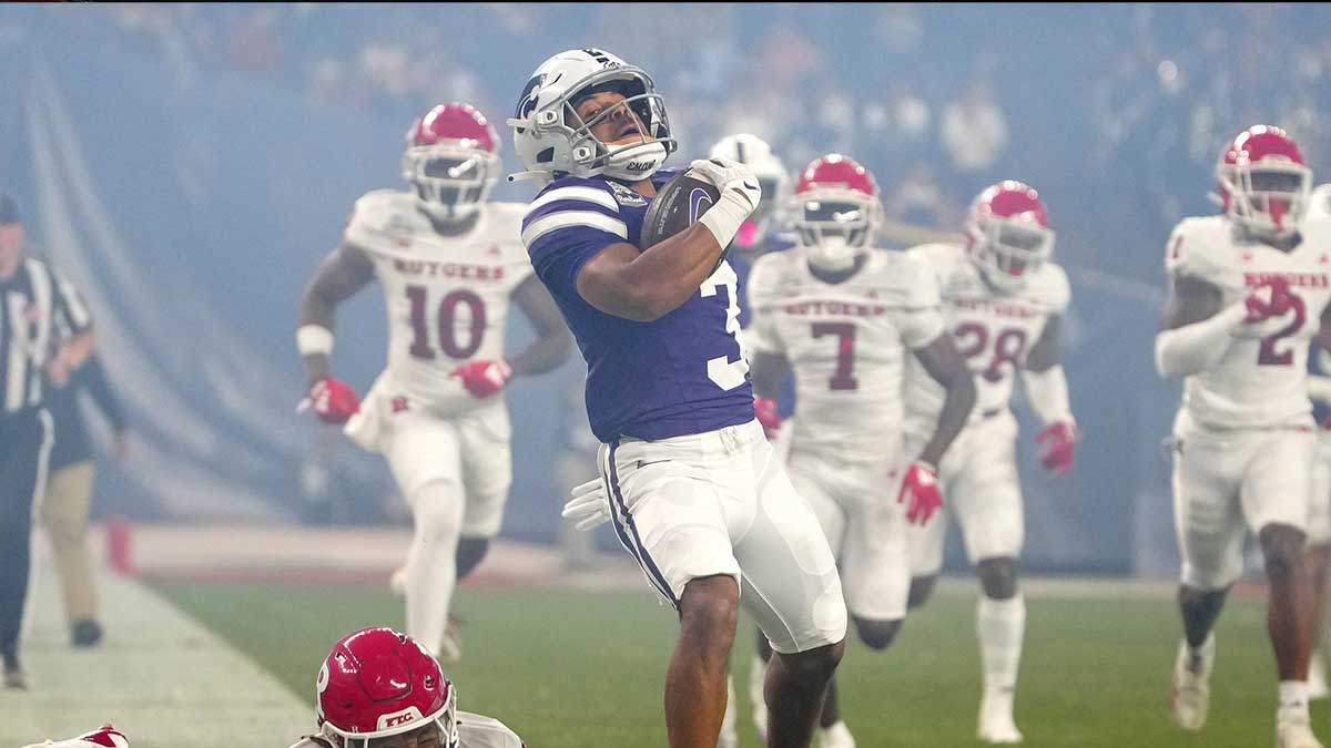 Kansas State running back Dylan Edwards (3) breaks a tackle from Rutgers safety Kaj Sanders (5) during first half of the Rate Bowl at Chase Field on Dec. 26, 2024, in Phoenix.