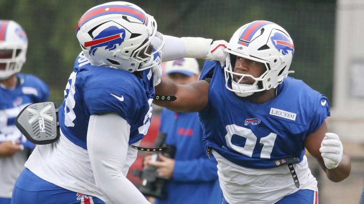 Bills defensive tackle Ed Oliver works to get around Zion Logue during position drills during day seven of Buffalo Bills training camp
