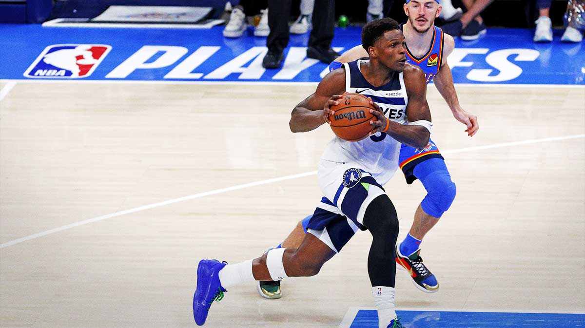 Minnesota Timberwolves guard Anthony Edwards (5) drives to the basket against Oklahoma City Thunder guard Alex Caruso (9) during the third quarter in game five of the western conference finals for the 2025 NBA Playoffs at Paycom Center.
