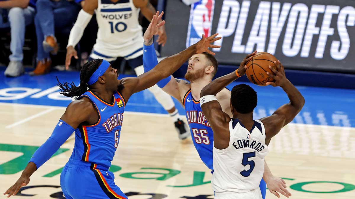 Minnesota Timberwolves guard Anthony Edwards (5) passes the ball against Oklahoma City Thunder guard Luguentz Dort (5) and center Isaiah Hartenstein (55) during the first quarter in game five of the western conference finals for the 2025 NBA Playoffs at Paycom Center.
