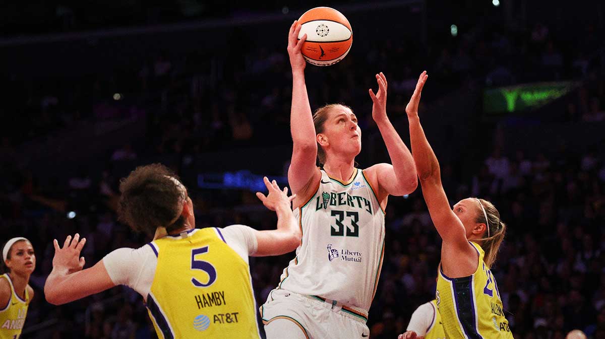 New York Liberty center Emma Meesseman (33) shoots the ball between Los Angeles Sparks forward Dearica Hamby (5) and guard Julie Allemand (20) during the fourth quarter at Crypto.com Arena.