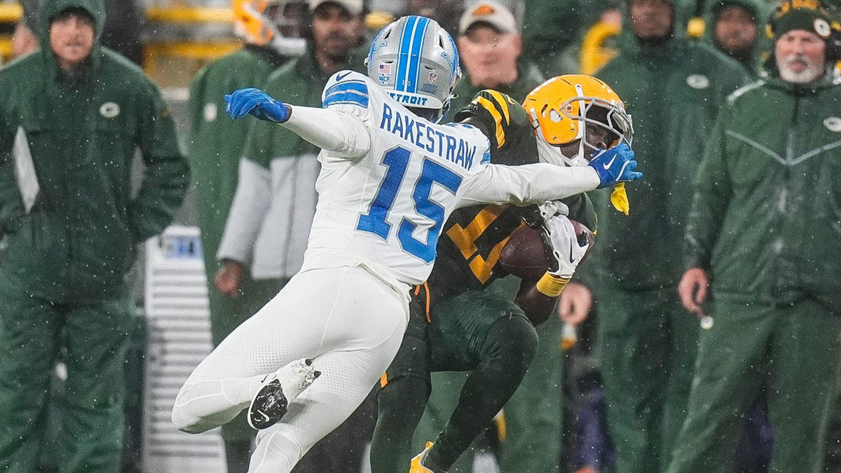 Detroit Lions cornerback Ennis Rakestraw Jr. (15) tackles Green Bay Packers wide receiver Jayden Reed (11) during the second half at Lambeau Field