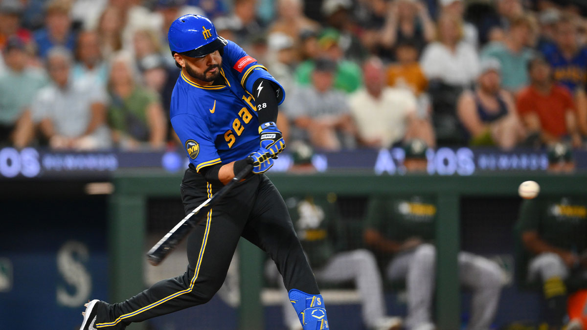 Aug 22, 2025; Seattle, Washington, USA; Seattle Mariners third baseman Eugenio Suarez (28) hits a home run against the Athletics during the fifth inning at T-Mobile Park.