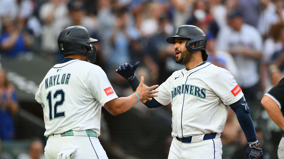 Seattle Mariners first baseman Josh Naylor (12) and third baseman Eugenio Suarez (28) celebrate after Suarez hit a 2-run home run against the Chicago White Sox during the fourth inning at T-Mobile Park.