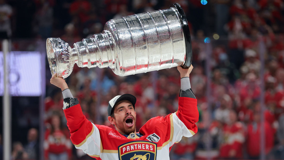 Florida Panthers center Evan Rodrigues (17) hoists the Stanley Cup after winning game six of the 2025 Stanley Cup Final against the Edmonton Oilers at Amerant Bank Arena.