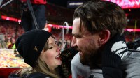 Recording artist Taylor Swift and Kansas City Chiefs tight end Travis Kelce (87) react after the AFC Championship game against the Buffalo Bills at GEHA Field at Arrowhead Stadium.