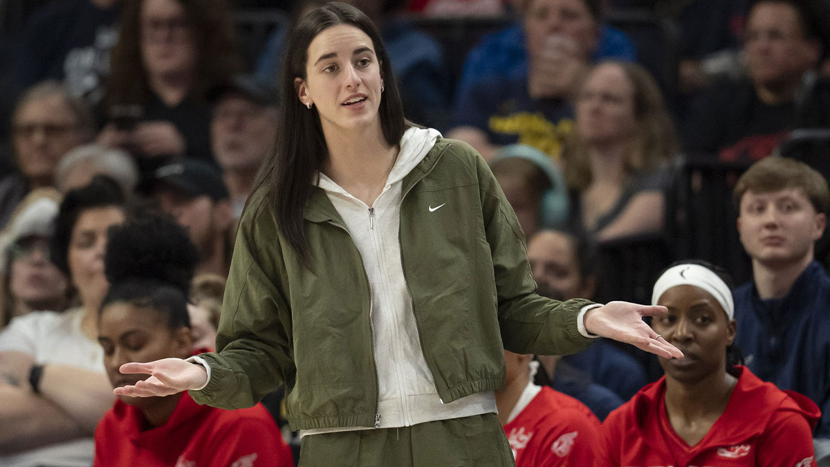 Indiana Fever guard Caitlin Clark (22) looks on from the bench against the Minnesota Lynx in the second half at Target Center.