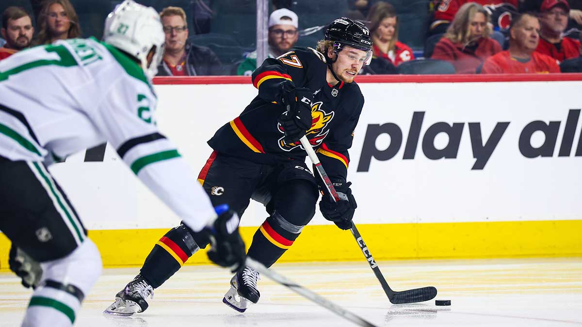 Calgary Flames center Connor Zary (47) controls the puck against the Dallas Stars during the first period at Scotiabank Saddledome.