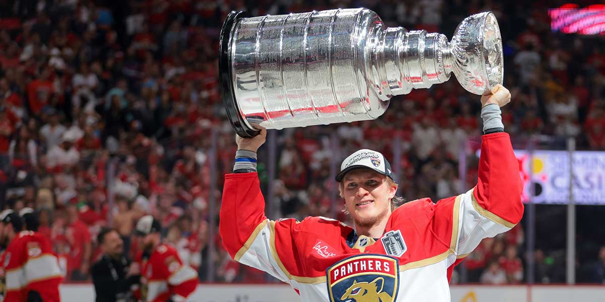Florida Panthers center Anton Lundell (15) hoists the Stanley Cup after winning game six of the 2025 Stanley Cup Final against the Edmonton Oilers at Amerant Bank Arena.