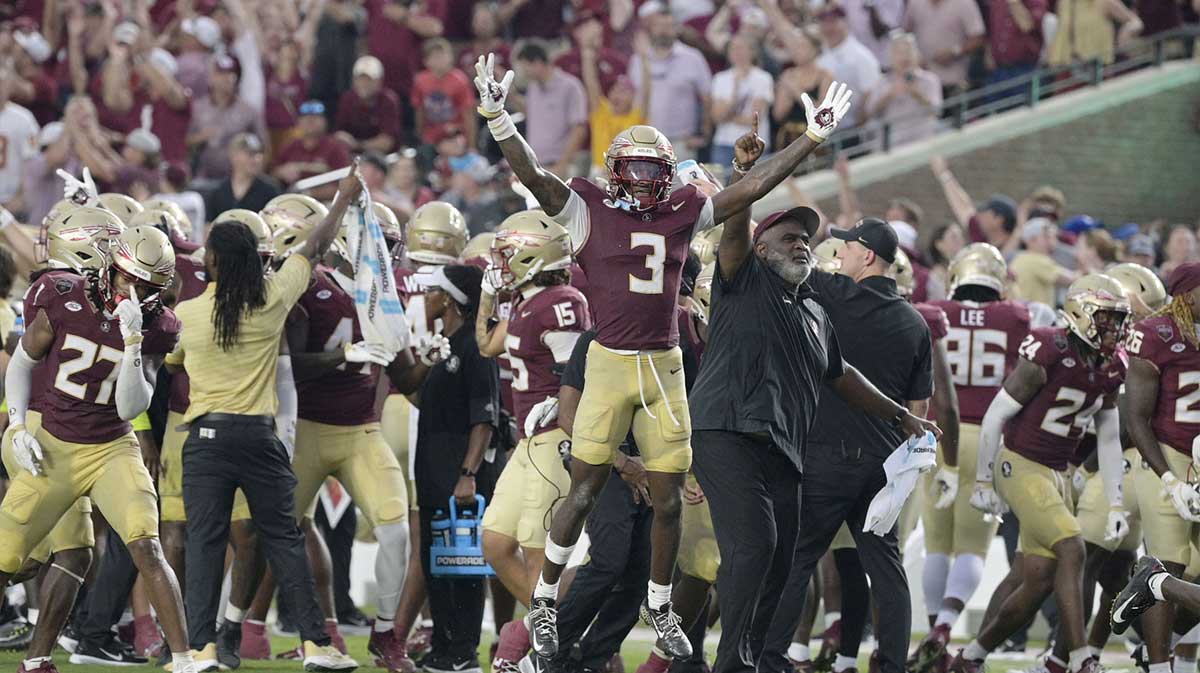 Florida State Seminoles running back Kam Davis (3) and associate head coach Odell Haggins react after a play Alabama Crimson Tide during the second half at Doak S. Campbell Stadium.