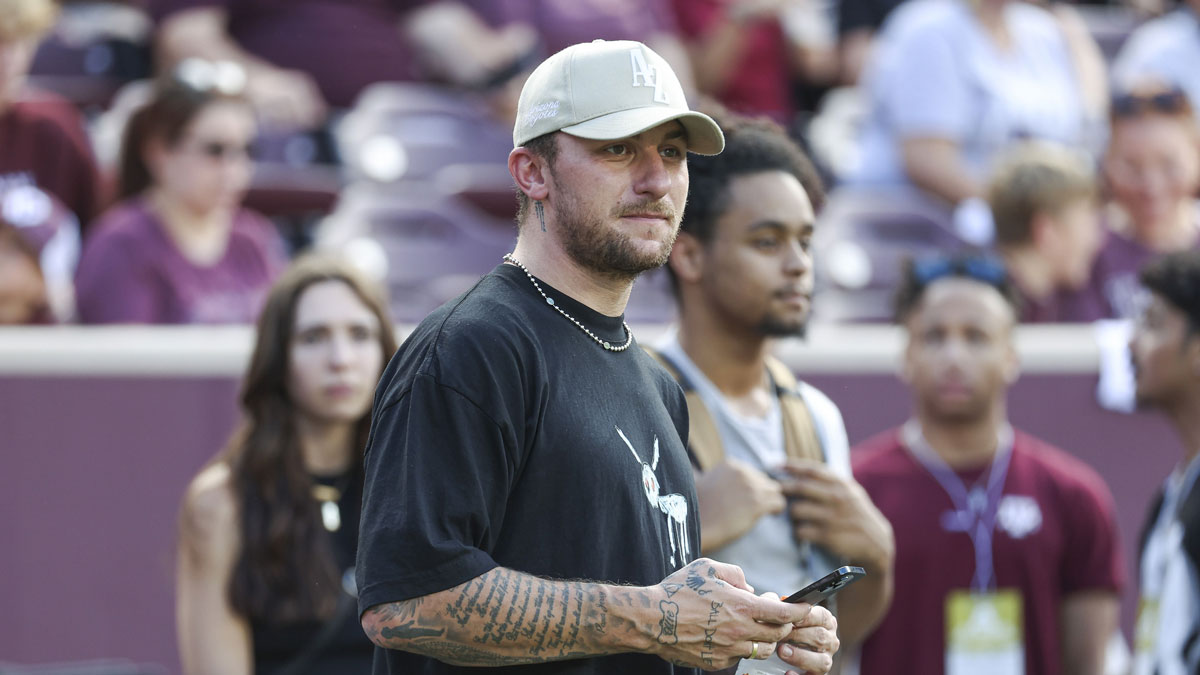 Former Texas A&M Aggies player Johnny Manziel watches from the sideline during the first half of the game between the Aggies and the Louisiana Monroe Warhawks at Kyle Field.