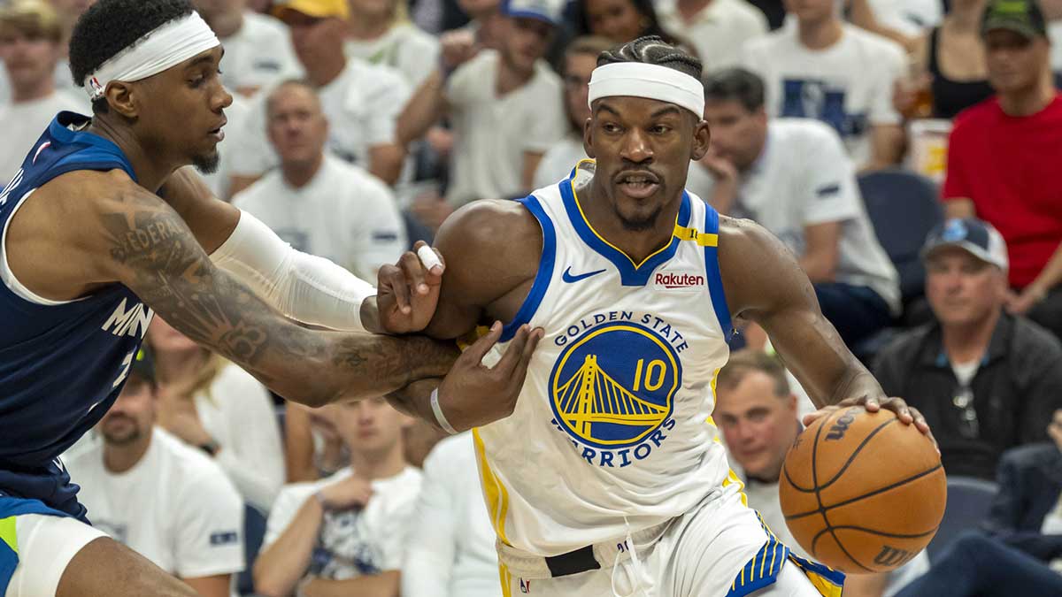 Warriors forward Jimmy Butler III (10) drives to the basket past Minnesota Timberwolves forward Jaden McDaniels (3) in the second half during game five of the second round for the 2025 NBA Playoffs at Target Center