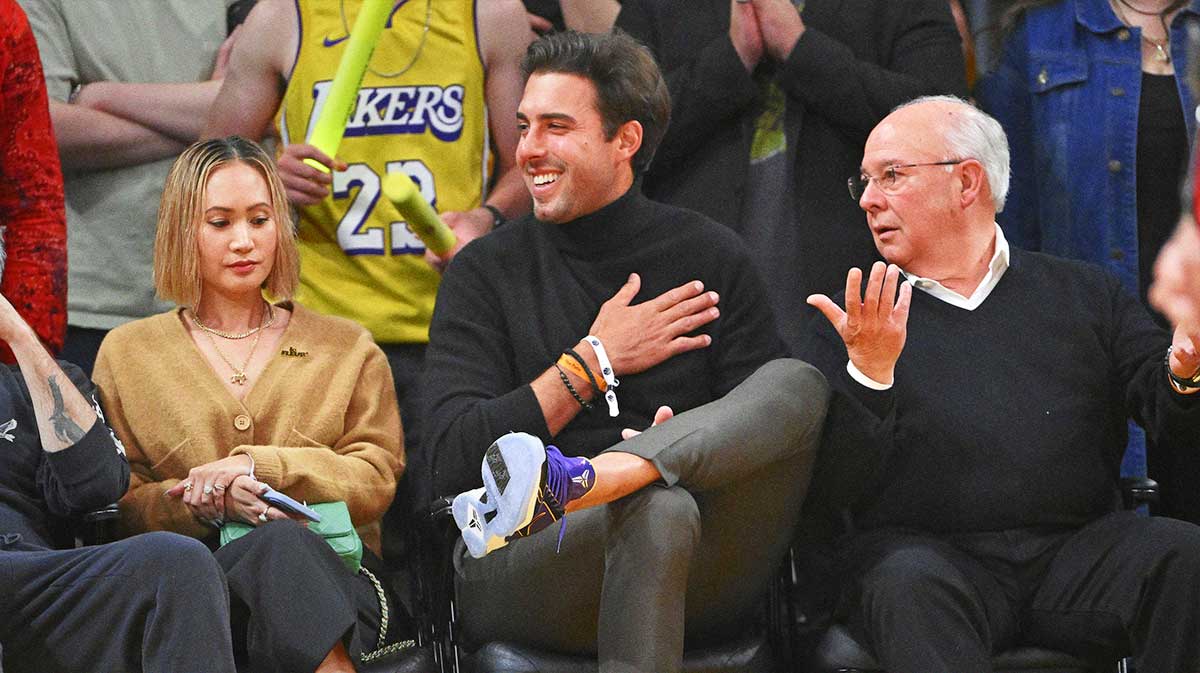 Lakers player Sasha Vujacic, center, attends game six of the 2023 NBA playoffs between the Los Angeles Lakers and the Memphis Grizzlies at Crypto.com Arena with the Mavericks logo in the background