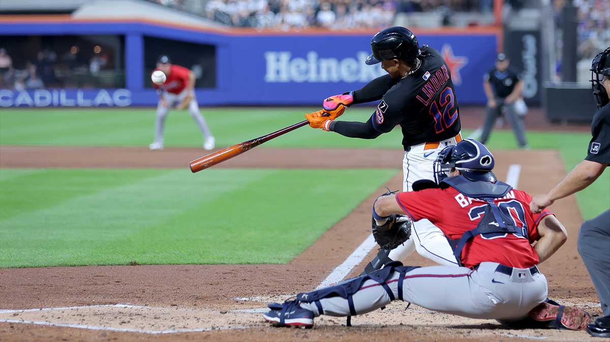 Aug 14, 2025; New York City, New York, USA; New York Mets shortstop Francisco Lindor (12) hits a solo home run against the Atlanta Braves during the third inning at Citi Field. 