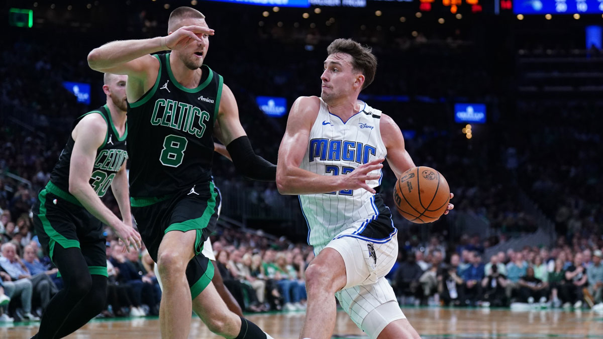 Orlando Magic forward Franz Wagner (22) drives the ball against Boston Celtics center Kristaps Porzingis (8) in the second quarter during game five of first round for the 2025 NBA Playoffs at TD Garden.