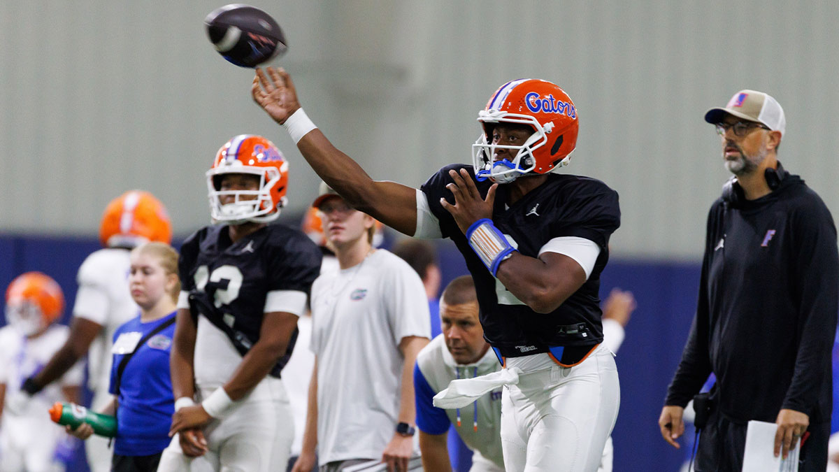 Florida Gators quarterback DJ Lagway (2) throws the ball while Florida Gators assistant coach for quarterbacks Ryan O'Hara looks on during fall football practice at Sanders Indoor Practice Fields at the University of Florida in Gainesville, FL on Thursday, August 7, 2025. [Matt Pendleton/Gainesville Sun]
