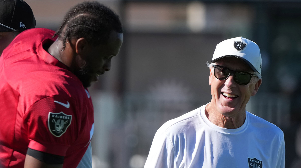 Las Vegas Raiders quarterback Geno Smith (7) with coach Pete Carroll during training camp