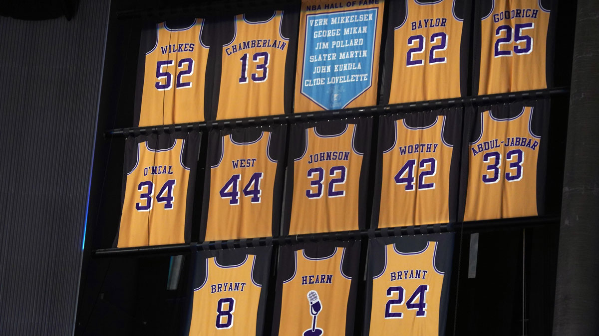 The retired jerseys of Los Angeles Lakers players Jamaal Wilkes (52), Wilt Chamberlain (13), Elgin Baylor (22), Shaquille O'Neal (34), Jerry West (44), Magic Johnson (32), James Worthy (42), Kareem Abdul-Jabbar (33), Kobe Bryant (8 and 24) and Chick Hearn and the names of Minneapolis Lakers Hall of Fame players Vern Mikkelsen, George Mikan, Jim Pollard, Slater Martin, John Kundla and Clyde Lovellette on display at Staples Center.