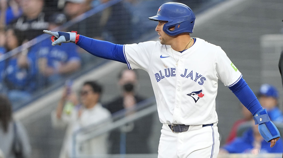 Toronto Blue Jays left fielder George Springer (4) gestures to shortstop Bo Bichette (not pictured) after scoring on his single against the Minnesota Twins during the first inning at Rogers Centre.
