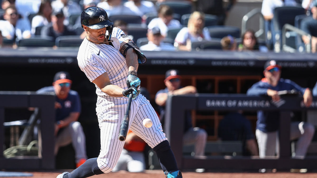 New York Yankees right fielder Giancarlo Stanton (27) hits an RBI single in the fifth inning against the Houston Astros at Yankee Stadium.