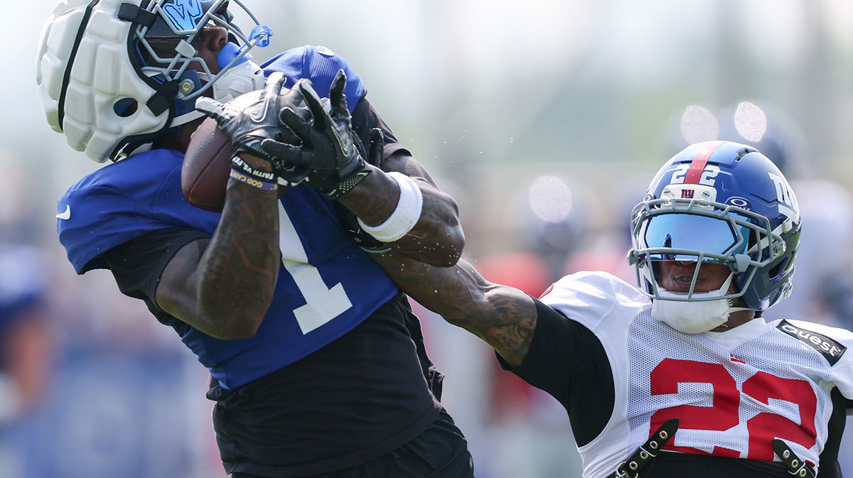 New York Giants wide receiver Malik Nabers (1) catches the ball as cornerback Dru Phillips (22) defends during training camp at Quest Diagnostics Training Center.