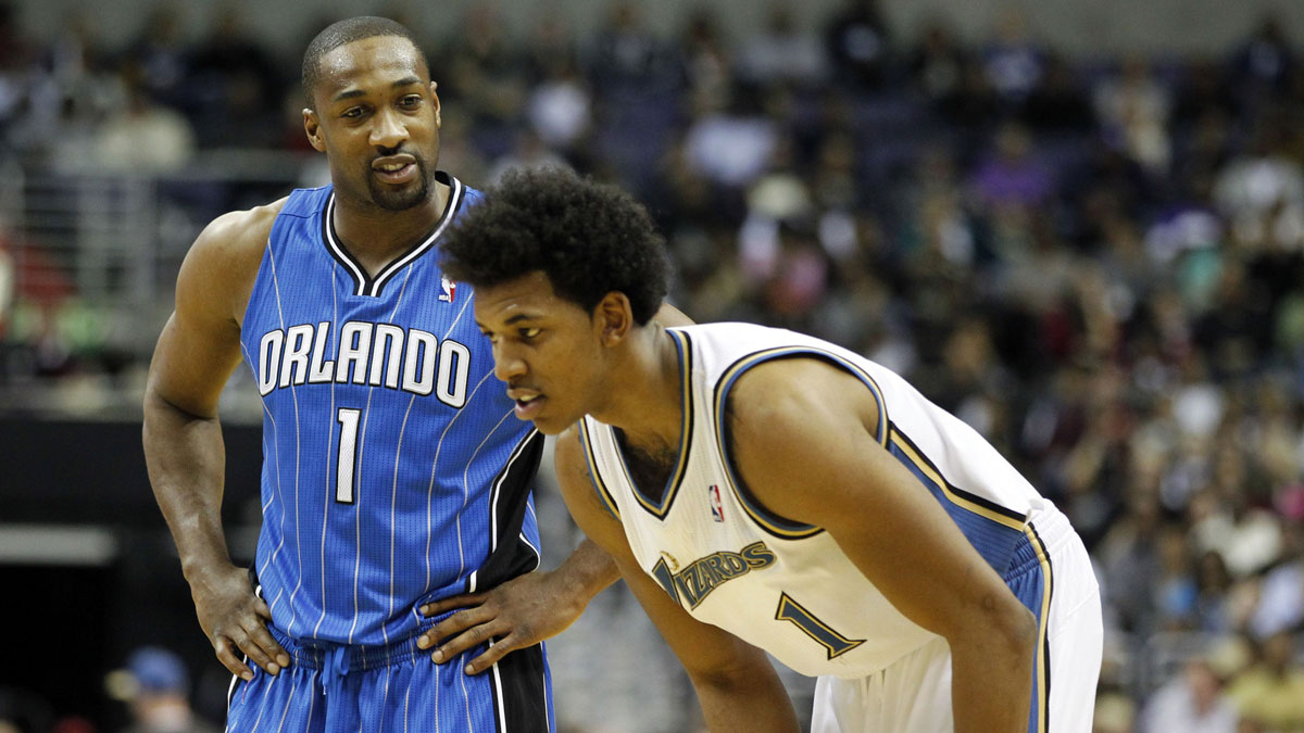 Magic point guard Gilbert Arenas (1) talks to Washington Wizards shooting guard Nick Young (1) on the court in the second half at Verizon Center. The Magic won 112-92