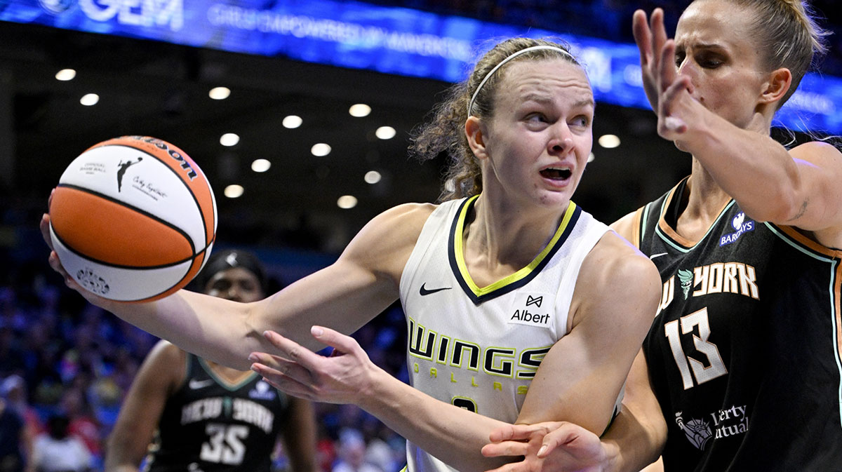 Dallas Wings guard Grace Berger (9) controls the ball in front of New York Liberty forward Leonie Fiebich (13) during the second half at College Park Center.