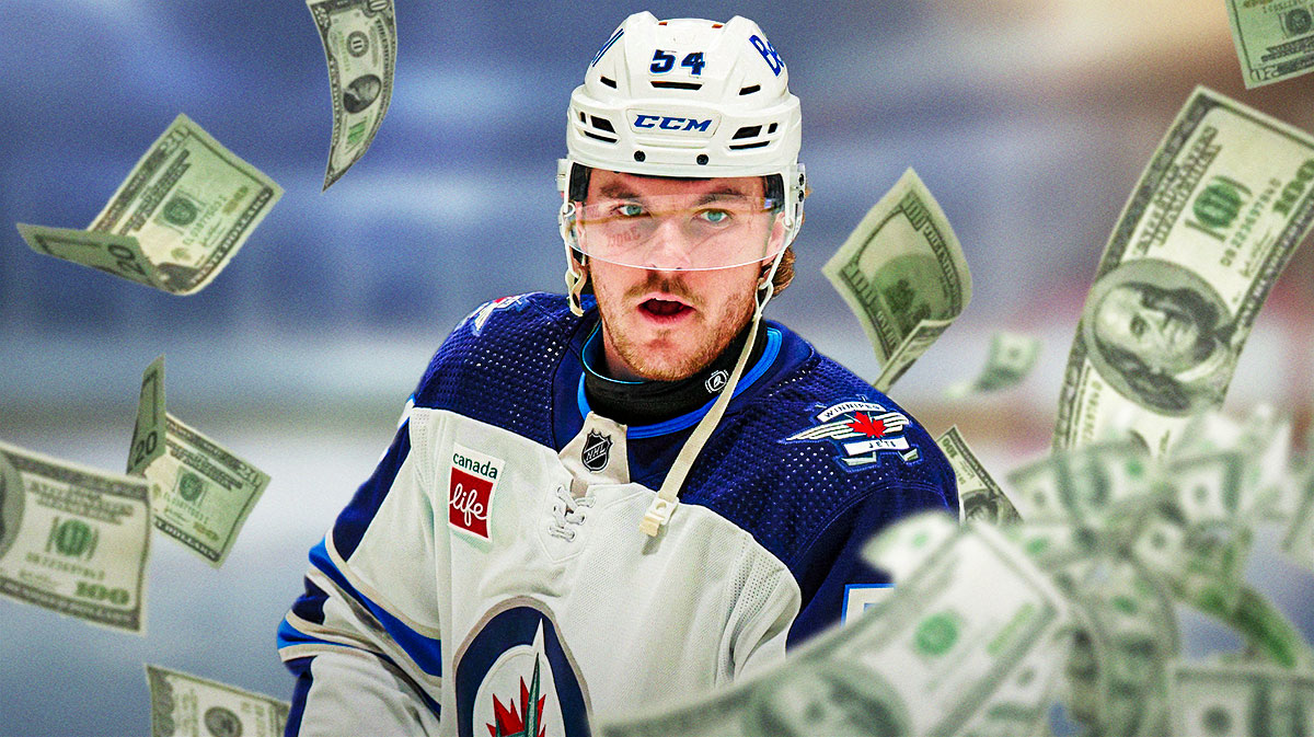 Dylan Samberg looking happy, money in image, hockey rink in background