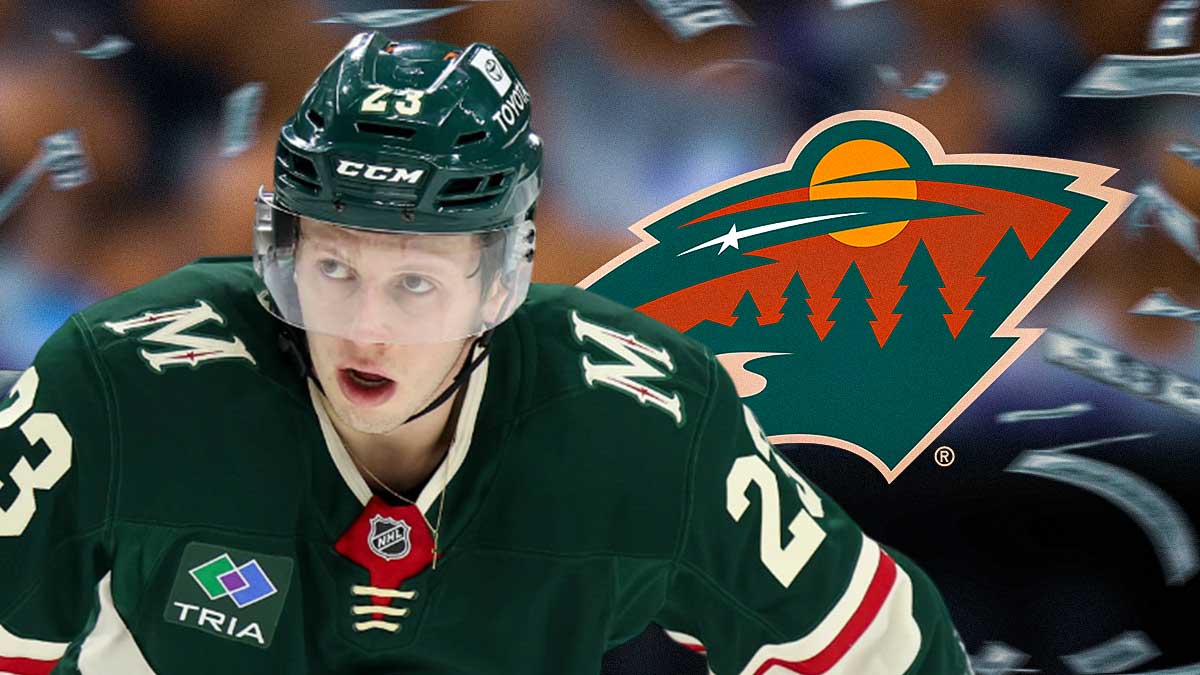 Marco Rossi with money around him and the Wild logo in the background.